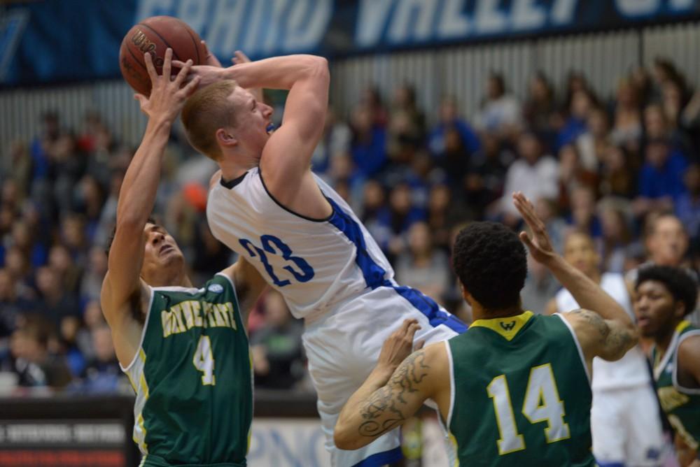 GVL / Luke Holmes - Luke Ryskamp (23) is hindered from going up for the shot. GVSU men’s basketball defeated Wayne State University on Thursday, Jan.19, 2017.