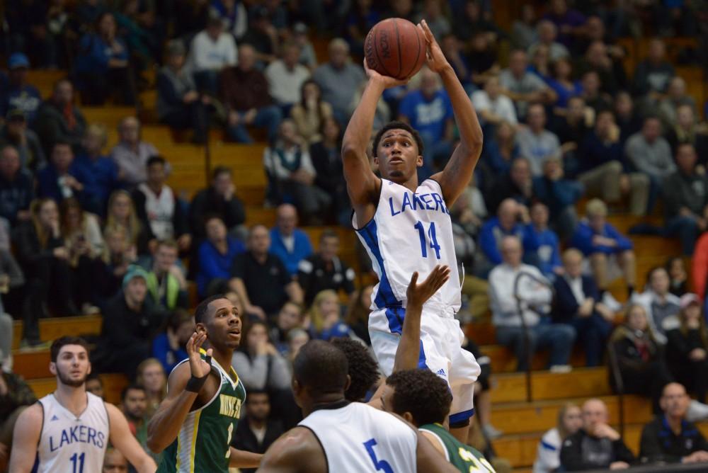 GVL / Luke Holmes - Chris Dorsey (14) jumps up for the shot. GVSU men’s basketball defeated Wayne State University on Thursday, Jan.19, 2017.