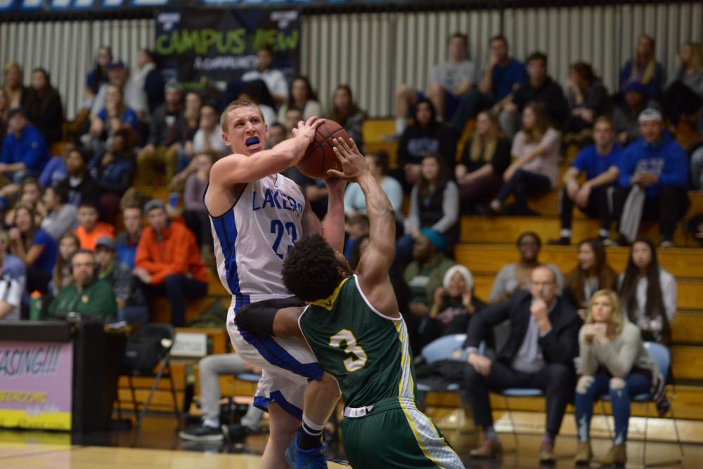 GVL / Luke Holmes - Luke Ryskamp (23) fights to keep the ball away from the defender. GVSU men’s basketball defeated Wayne State University on Thursday, Jan.19, 2017.