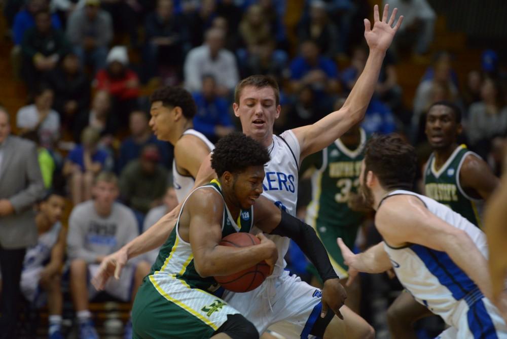 GVL / Luke Holmes - Alec Marty (20) stays close to his defender. GVSU men’s basketball defeated Wayne State University on Thursday, Jan.19, 2017.