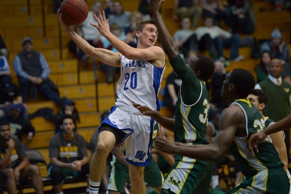 GVL / Luke Holmes - Alec Marty (20) attempts to pass the ball over the defenders. GVSU men’s basketball defeated Wayne State University on Thursday, Jan.19, 2017.