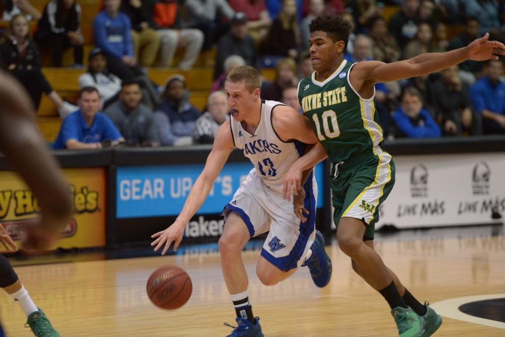 GVL / Luke Holmes - Luke Ryskamp (23) charges down the court with the ball. GVSU men’s basketball defeated Wayne State University on Thursday, Jan.19, 2017.