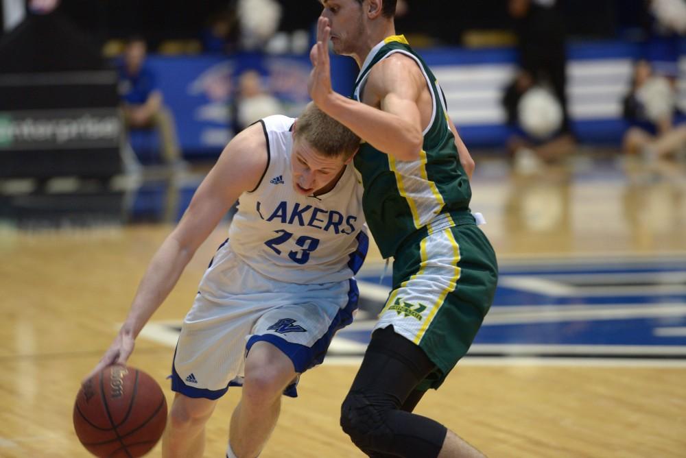 GVL / Luke Holmes - Luke Ryskamp (23) powers past the defender. GVSU men’s basketball defeated Wayne State University on Thursday, Jan.19, 2017.