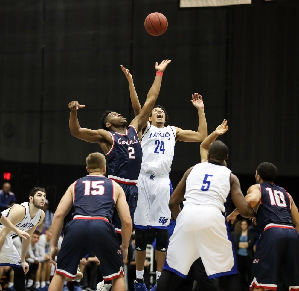 GVL/Kevin Sielaff - Justin Greason (24) leaps up and wins the tip over Saginaw's C.J. Turnage (2) during the game inside the Fieldhouse Arena as Grand Valley squares off against SVSU on Saturday, Jan. 21, 2017. The Lakers took the victory with a final score of 80-71.