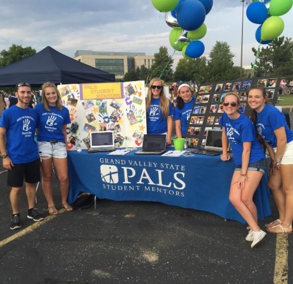 GVL / Courtesy - GVSU PalsThe Grand Valley State Pals Student Mentor group poses for a photo at Campus Life Night in parking lot H on Tuesday, Sept. 6, 2016.
