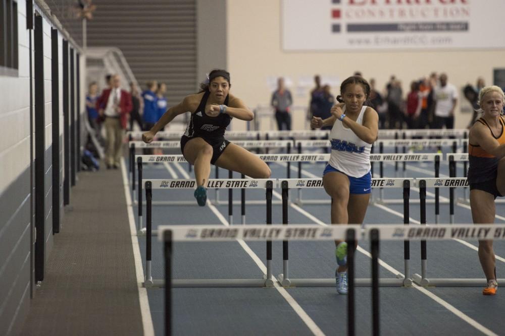 GVL / Luke Holmes - Victoria Patton jumps over the hurdles. The GVSU Lints Alumni Meet was held in the Kelly Family Sports Center on Saturday, Jan. 29, 2016.