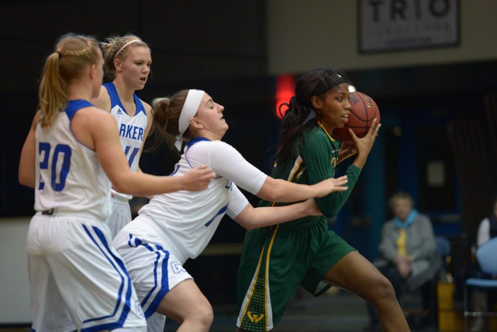 GVL / Luke Holmes - Kayla Dawson (23) tries to rip the ball away from the opponent’s possesion. GVSU Women’s Basketball defeated Wayne State University on Thursday, Jan.19, 2017.