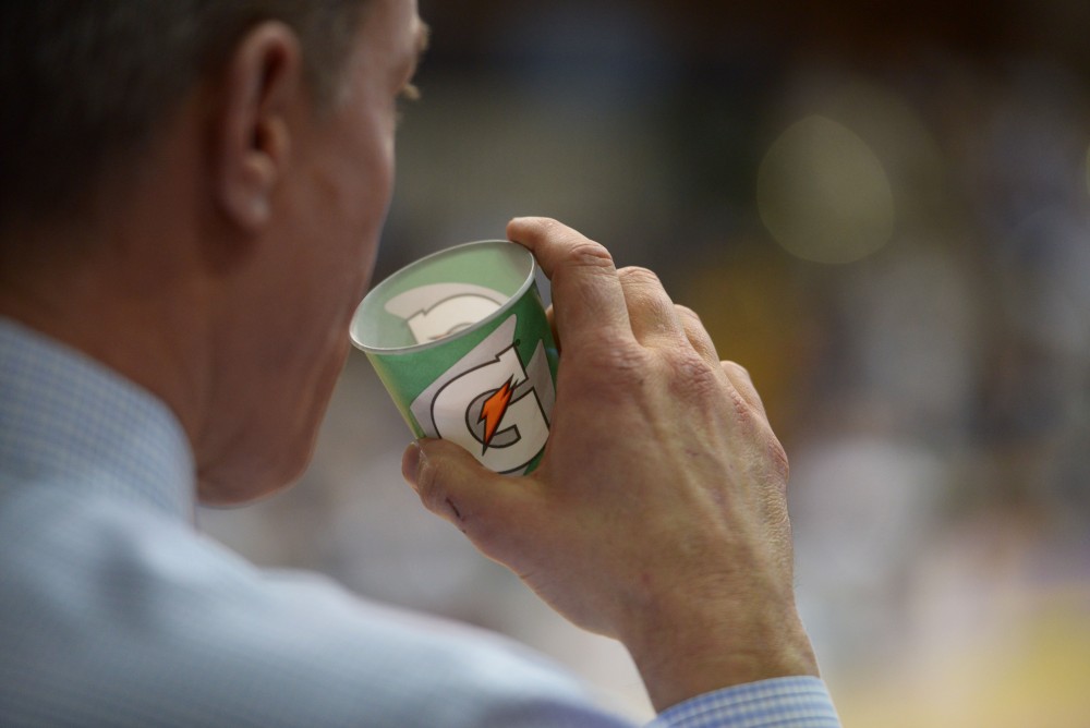 GVL / Luke Holmes - Coach Mike Williams sips water from a Gatorade™ cup on the sideline. GVSU Women’s Basketball defeated Wayne State University on Thursday, Jan.19, 2017.