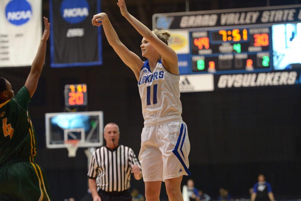 GVL / Luke Holmes - Piper Tucker (11) shoots from outside the arc. GVSU Women’s Basketball defeated Wayne State University on Thursday, Jan.19, 2017.