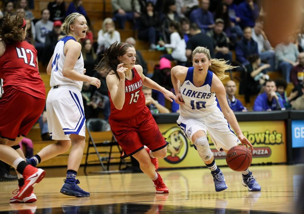 GVL/Kevin Sielaff - Taylor Lutz (10) gets a stop of Saginaw's Katelyn Carriere (15) and drives in for a lay-up during the game inside the Fieldhouse Arena as Grand Valley squares off against SVSU on Saturday, Jan. 21, 2017. The Lakers took the victory with a final score of 63-57.