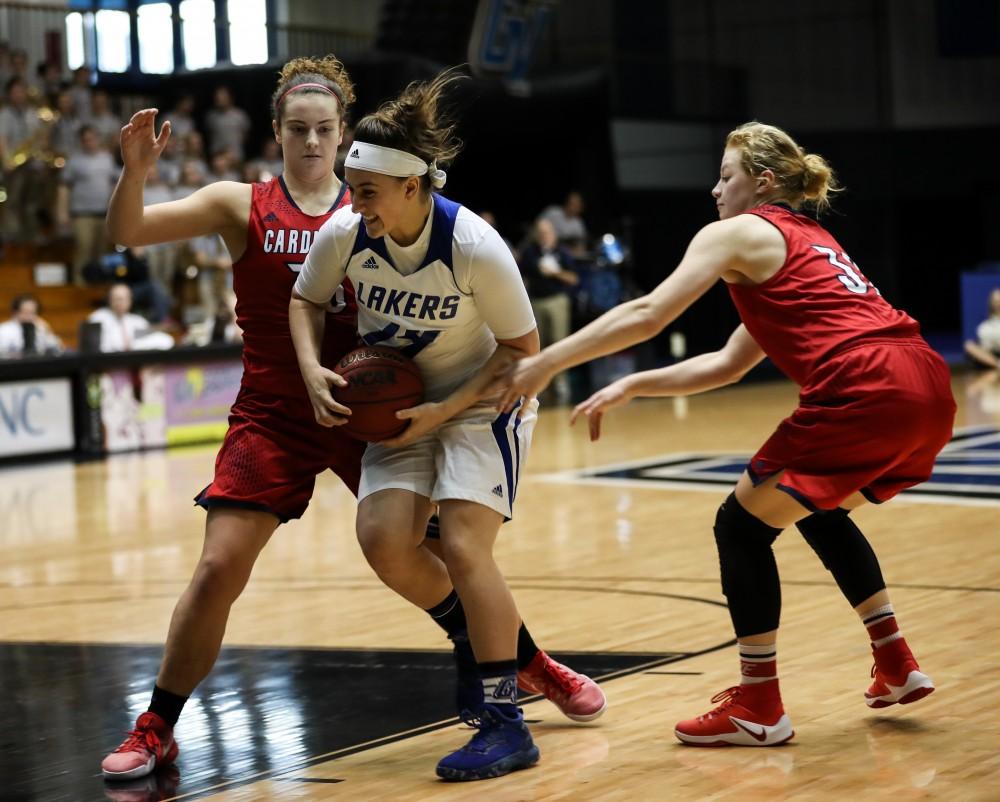 GVL/Kevin Sielaff - Taylor Parmley (14), harassed by Saginaw's defense, drives to the hoop and converts during the game inside the Fieldhouse Arena as Grand Valley squares off against SVSU on Saturday, Jan. 21, 2017. The Lakers took the victory with a final score of 63-57.