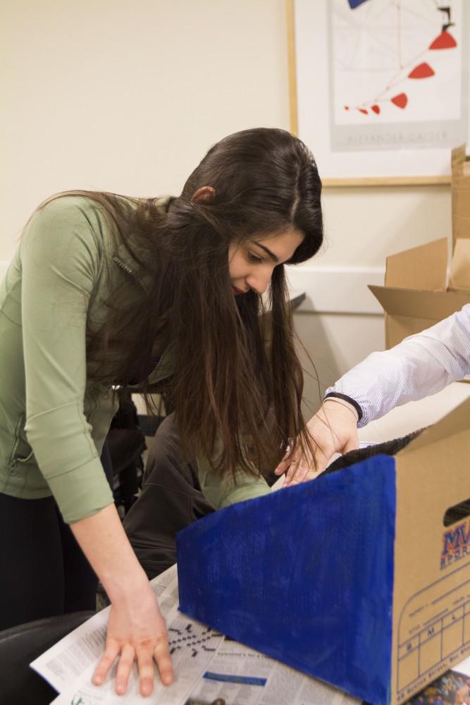 GVL/Mackenzie Bush - Emma Weintraub prepares her board game for the upcoming GVSU Winter Cardboard Challenge Friday, Feb. 17, 2017 in Mackinaw Hall.