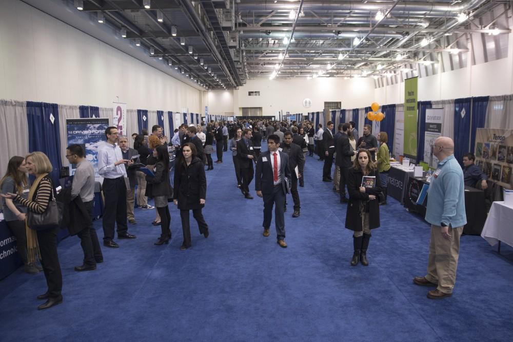 GVL / Luke Holmes - Zachary Grule prepares his folder before talking to employers. The Career Fair was held in the DeVos Place on Thursday, Feb. 23, 2016.