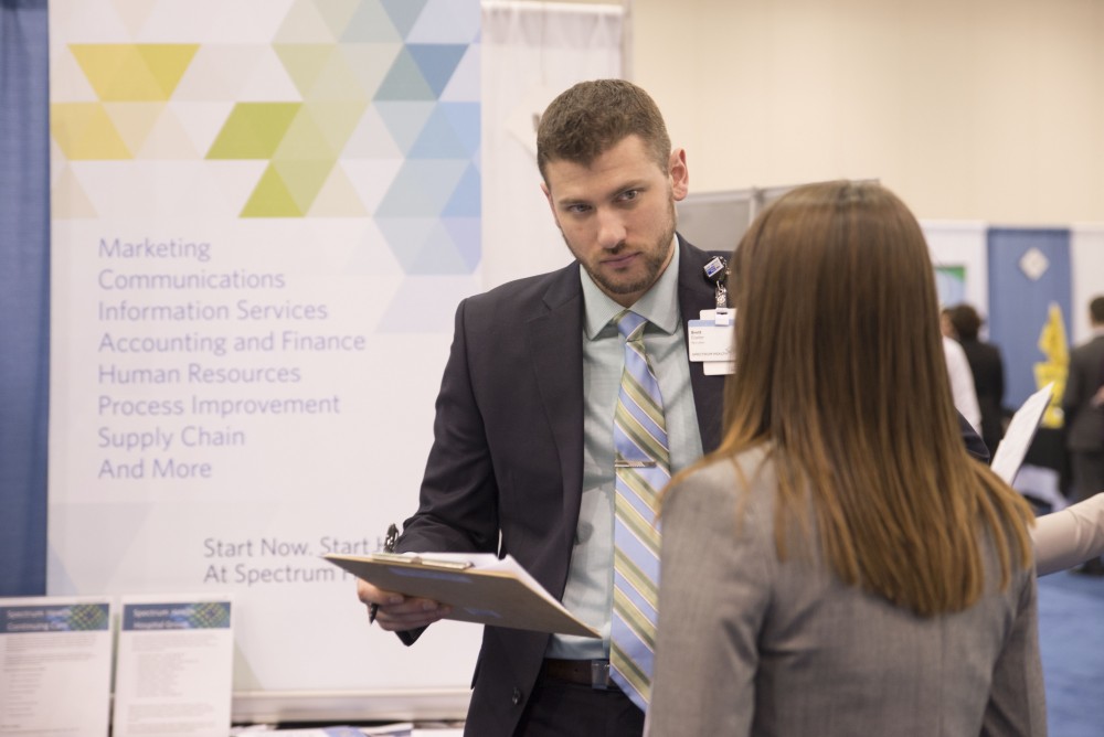 GVL / Luke Holmes - A student talks to Brett Eiseler. The Career Fair was held in the DeVos Place on Thursday, Feb. 23, 2016.