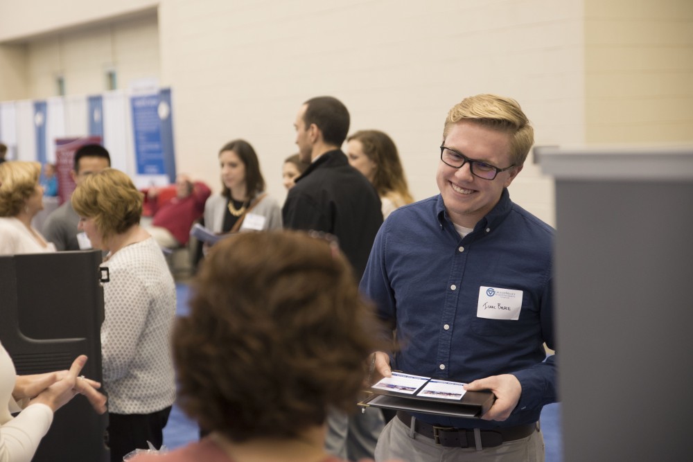 GVL / Luke Holmes - Isaac Brace talks to a potential employer. The Career Fair was held in the DeVos Place on Thursday, Feb. 23, 2016.