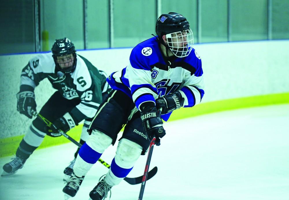 GVL / Emily Frye      
Buck Maynard takes the puck down the ice during the game against Michigan State on Friday Jan. 27, 2017. 