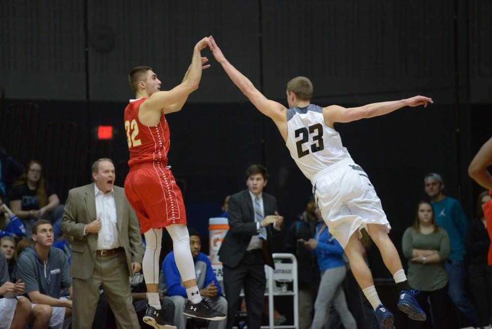 GVL / Luke Holmes - Drake Baar (21) pops one up over his defender. GVSU Men’s Basketball defeated Michigan Tech in the Fieldhouse Arena on Thursday, Feb. 16, 2017.