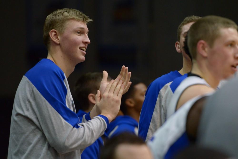 GVL / Luke Holmes - John Rexroth (35) claps from the bench. GVSU Men’s Basketball defeated Michigan Tech in the Fieldhouse Arena on Thursday, Feb. 16, 2017.