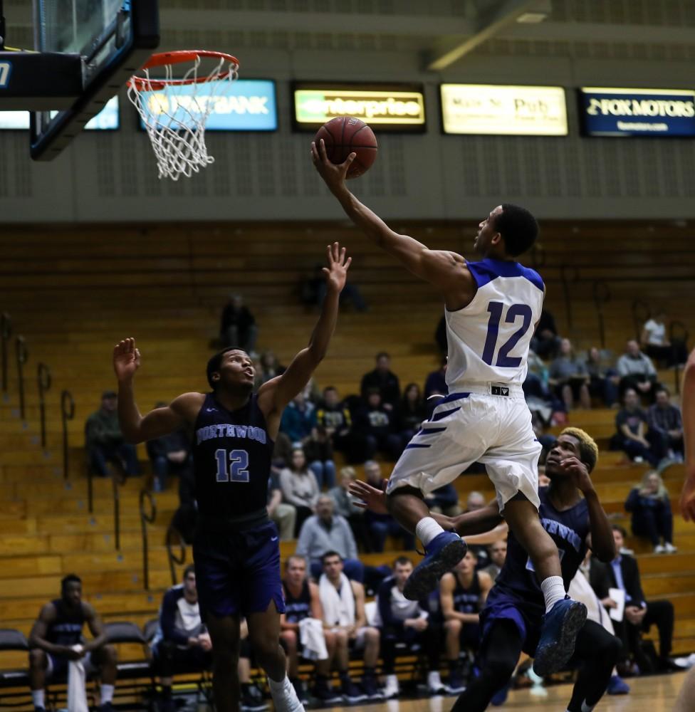 Myles Miller (12) drives to the hoop during the game vs. Northwood inside the Fieldhouse Arena in Allendale on Thursday, Feb. 9, 2017. 