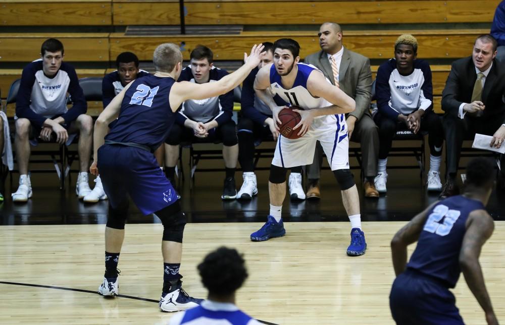 Zach West (11) picks up his dribble and looks to pass during the game vs. Northwood inside the Fieldhouse Arena in Allendale on Thursday, Feb. 9, 2017. 