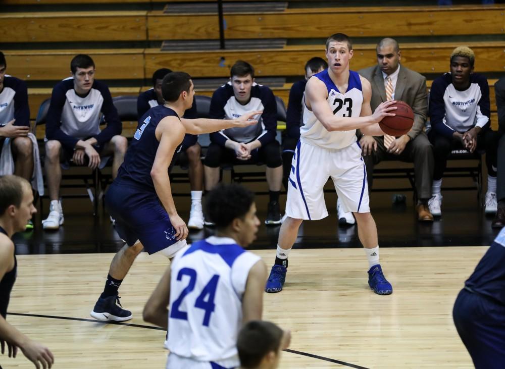 Luke Ryskamp (23) picks up his dribble and looks to pass during the game vs. Northwood inside the Fieldhouse Arena in Allendale on Thursday, Feb. 9, 2017. 