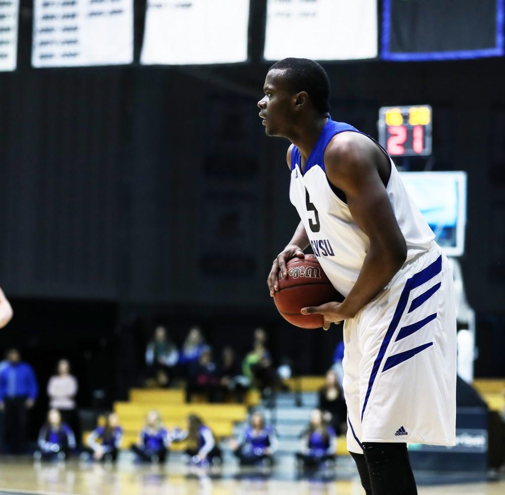 Trevin Alexander (5) picks up his dribble at the top of the arc and looks to pass during the game vs. Northwood inside the Fieldhouse Arena in Allendale on Thursday, Feb. 9, 2017. 