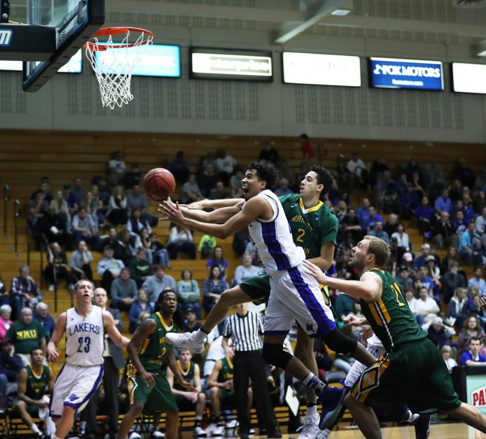 GVL/Kevin Sielaff - Justin Greason (24) goes in for a layup during the game against Northern Michigan on Saturday, Feb. 18, 2017 inside the Fieldhouse Arena in Allendale.