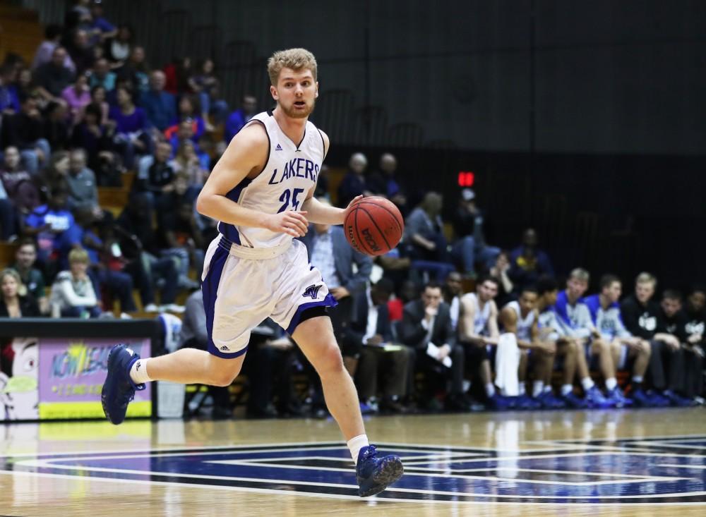 GVL/Kevin Sielaff - Ben Lubitz (25) carries the ball around the arc during the game against Northern Michigan on Saturday, Feb. 18, 2017 inside the Fieldhouse Arena in Allendale.