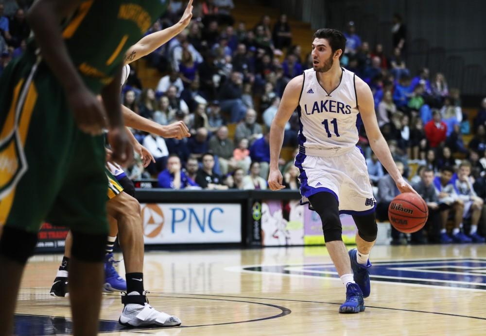 GVL/Kevin Sielaff - Zach West (11) carries the ball around the arc during the game against Northern Michigan on Saturday, Feb. 18, 2017 inside the Fieldhouse Arena in Allendale.