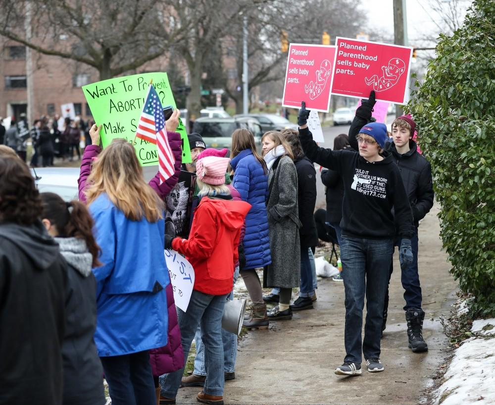 Isaac Buehler and his brother Josh Buehler, of Zeeland, protest Planned Parenthood in front of the Planned Parenthood building on 425 Cherry St SE in Grand Rapids on Saturday, Feb. 11, 2017. 