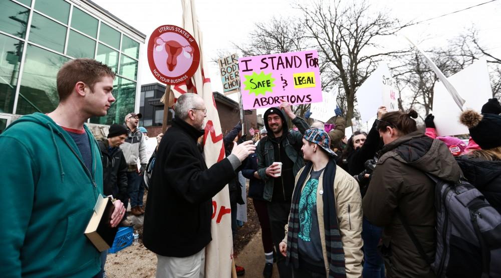 Protesters and supporters gather in front of Planned Parenthood on  425 Cherry St SE in Grand Rapids on Saturday, Feb. 11, 2017. 