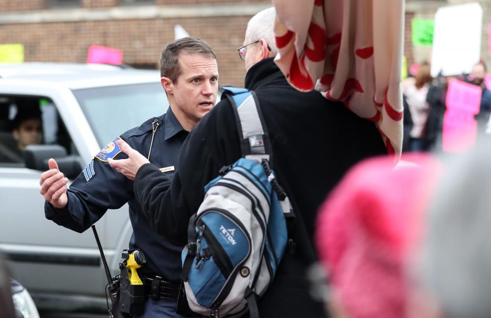 Grand Rapids Police Department's officer Brad Bush controls the crowd in front of the Planned Parenthood building on  425 Cherry St SE in Grand Rapids on Saturday, Feb. 11, 2017. 