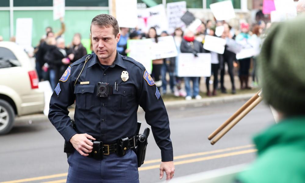 Grand Rapids Police Department's officer Brad Bush controls the crowd in front of the Planned Parenthood building on  425 Cherry St SE in Grand Rapids on Saturday, Feb. 11, 2017. 