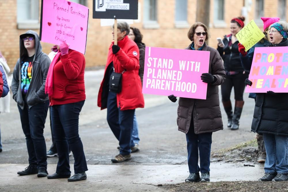 Protesters and supporters gather in front of Planned Parenthood on  425 Cherry St SE in Grand Rapids on Saturday, Feb. 11, 2017. 