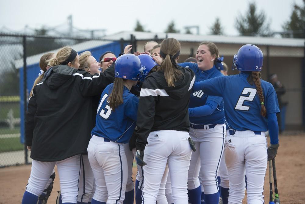 GVL / Luke Holmes - The team celebrates after a home run is hit. Grand Valley Womens Softball won 9-5 in their first game against Lake Superior State.