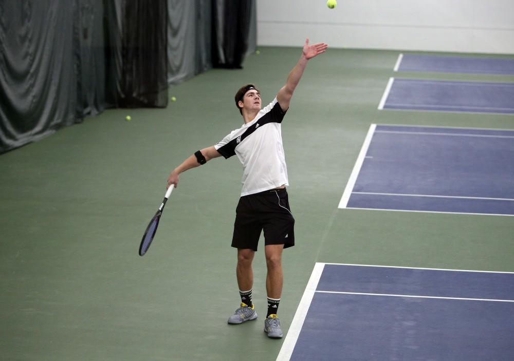 GVL / Emily Frye 
Junior Zach Phillips serves the ball during a match against Daemen College on Feb. 14, 2016.