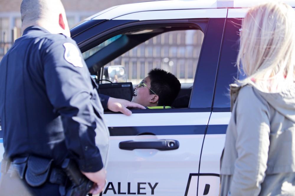 GVL / Emily Frye      
Local kids get the chance to sit front seat in Officer Minh Lien's cruzer on Saturday Feb. 18, 2017.