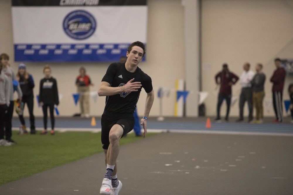 GVL / Luke Holmes - Hunter Weeks gets a running start before high jumping. The GVSU Lints Alumni Meet was held in the Kelly Family Sports Center on Saturday, Jan. 29, 2017.