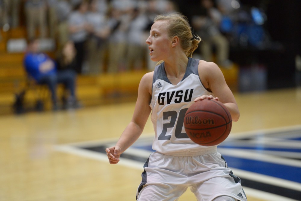 GVL / Luke Holmes - Piper Tucker (11) reaches her arm out toward the ball. GVSU Women’s Basketball defeated Michigan Tech in the Fieldhouse Arena on Thursday, Feb. 16, 2017.