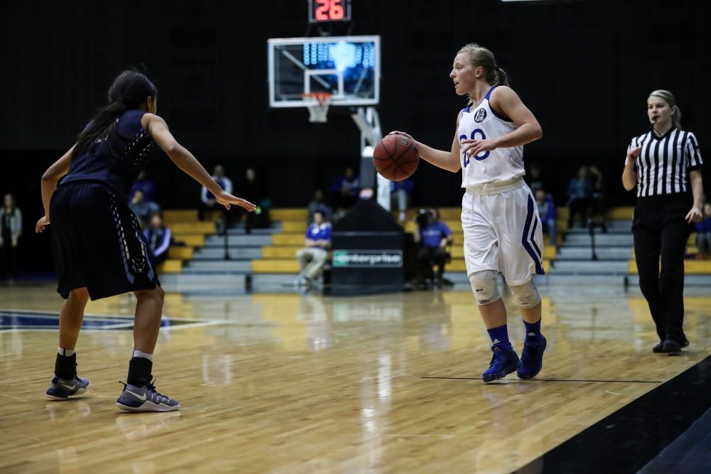 Janae Langs (20) controls the ball at the top of the arc during the game vs. Northwood inside the Fieldhouse Arena in Allendale on Thursday, Feb. 9, 2017. 