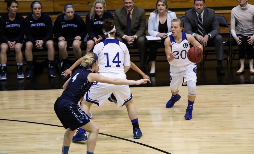 Janae Langs (20) possesses the ball as Taylor Parmley (14) sets a pick  during the game vs. Northwood inside the Fieldhouse Arena in Allendale on Thursday, Feb. 9, 2017. 