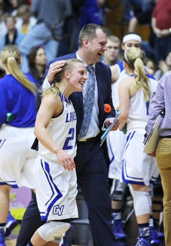 GVL/Kevin Sielaff - Janae Langs (20) celebrates her game winning shot with Assistant Coach Phil Sayers after the game against Northern Michigan on Saturday, Feb. 18, 2017 inside the Fieldhouse Arena in Allendale.