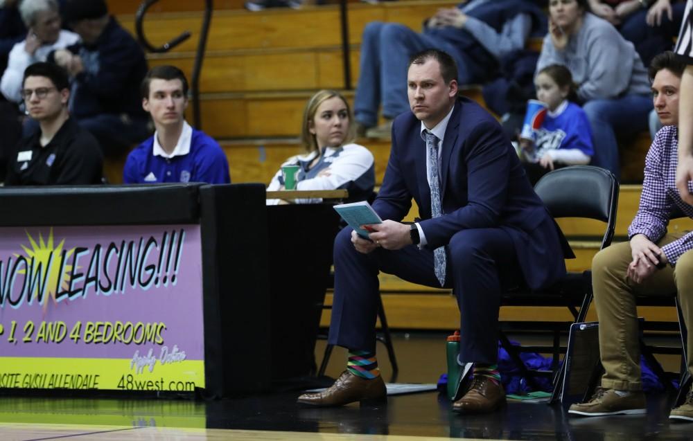 GVL/Kevin Sielaff - Assistant coach Phil Sayers looks on toward the play from the bench during the game against Northern Michigan on Saturday, Feb. 18, 2017 inside the Fieldhouse Arena in Allendale.