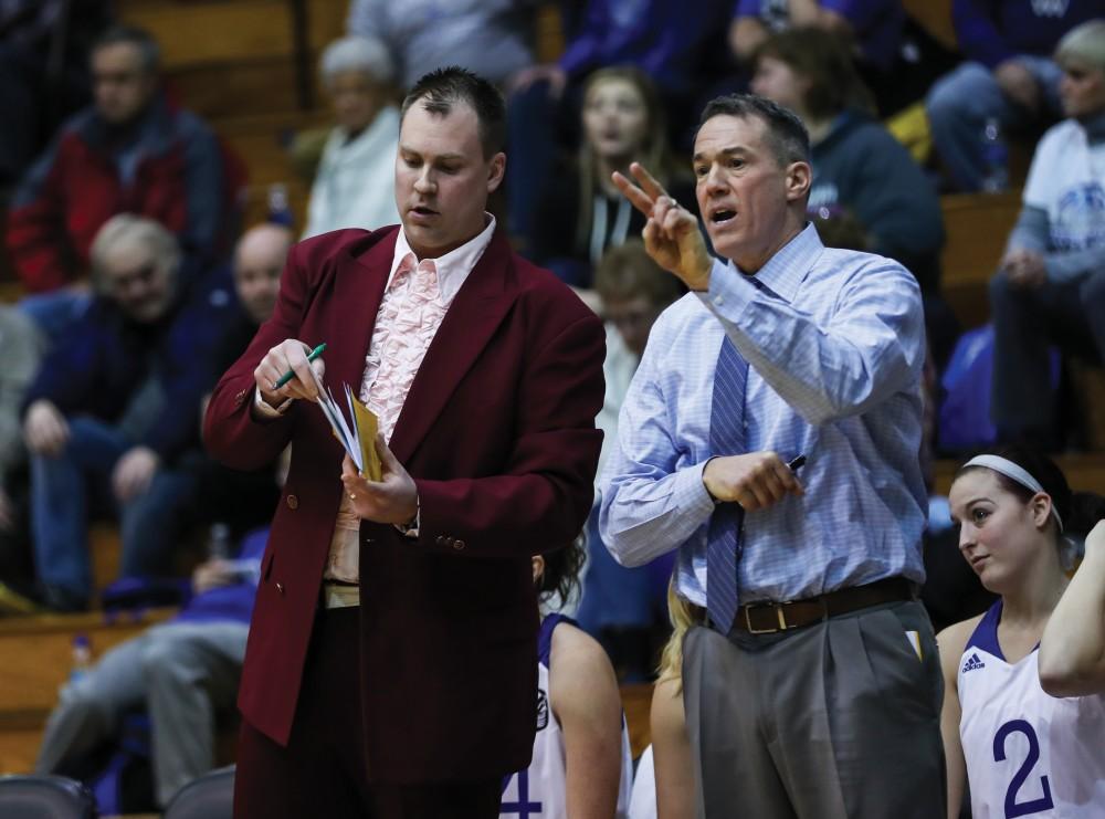 Head coach Mike Williams and Assistant Head Coach Phil Sayers talk on the bench during the game vs. Northwood inside the Fieldhouse Arena in Allendale on Thursday, Feb. 9, 2017. 