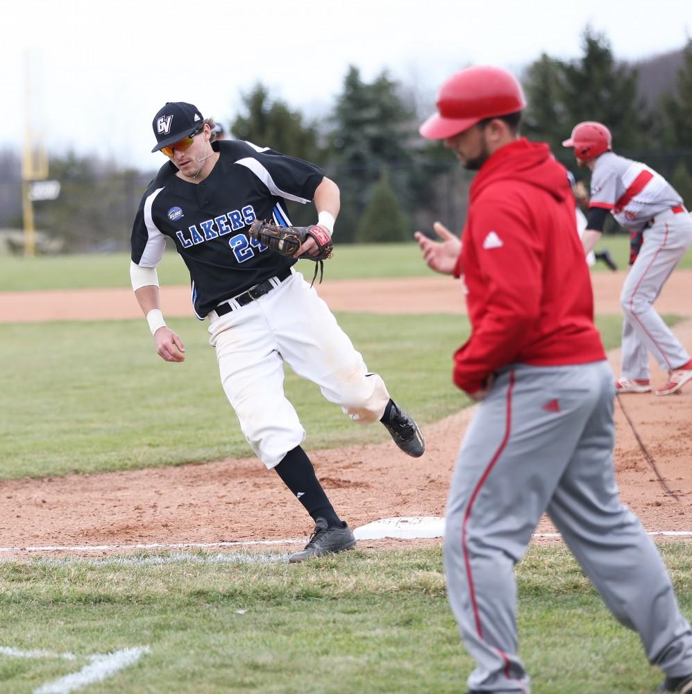 GVL/Kevin Sielaff - Austin LaDoux (24) tags an out at first during the game vs. Lewis University on Wednesday, March 29, 2017. 