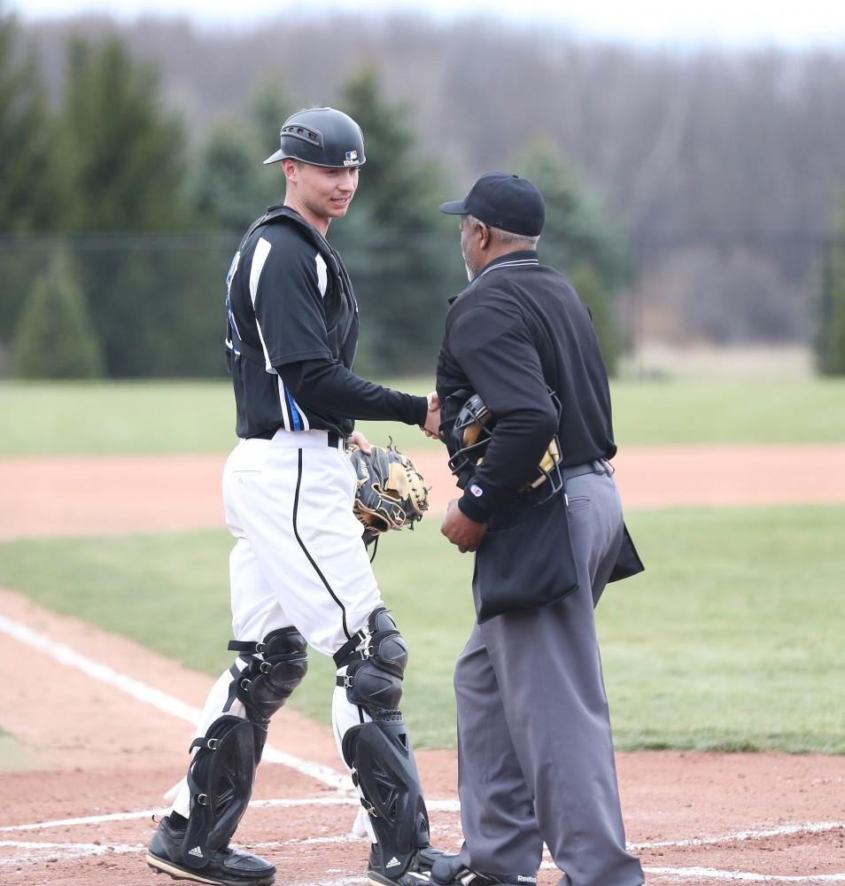 GVL/Kevin Sielaff - Connor Glick (16) shakes hands with the umpire before the start of the game vs. Lewis University on Wednesday, March 29, 2017. 