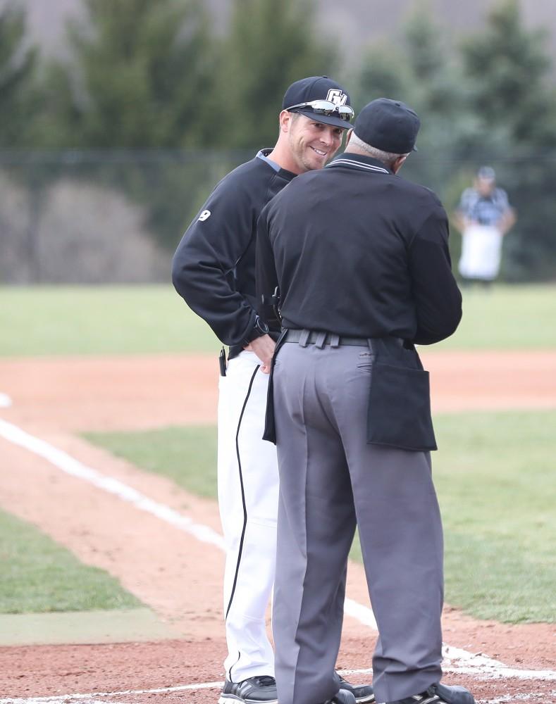 GVL/Kevin Sielaff - Head coach Jamie Detillion meets with the umpire before the start of the game vs. Lewis University on Wednesday, March 29, 2017. 