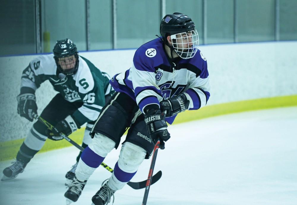 GVL / Emily Frye      
Buck Maynard takes the puck down the ice during the game against Michigan State on Friday Jan. 27, 2017. 