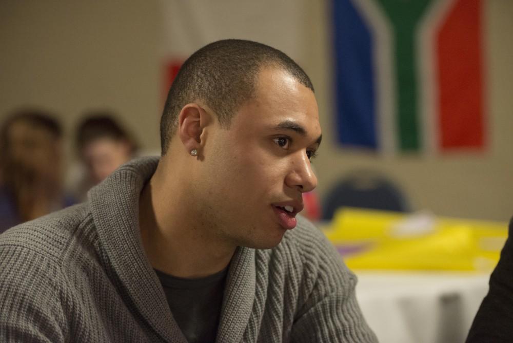 GVL / Luke Holmes - Andre Bowser talks with friends before the show begins. Sexy Accents Night was held in the Grand River Room on Tuesday, Mar. 21, 2017. 