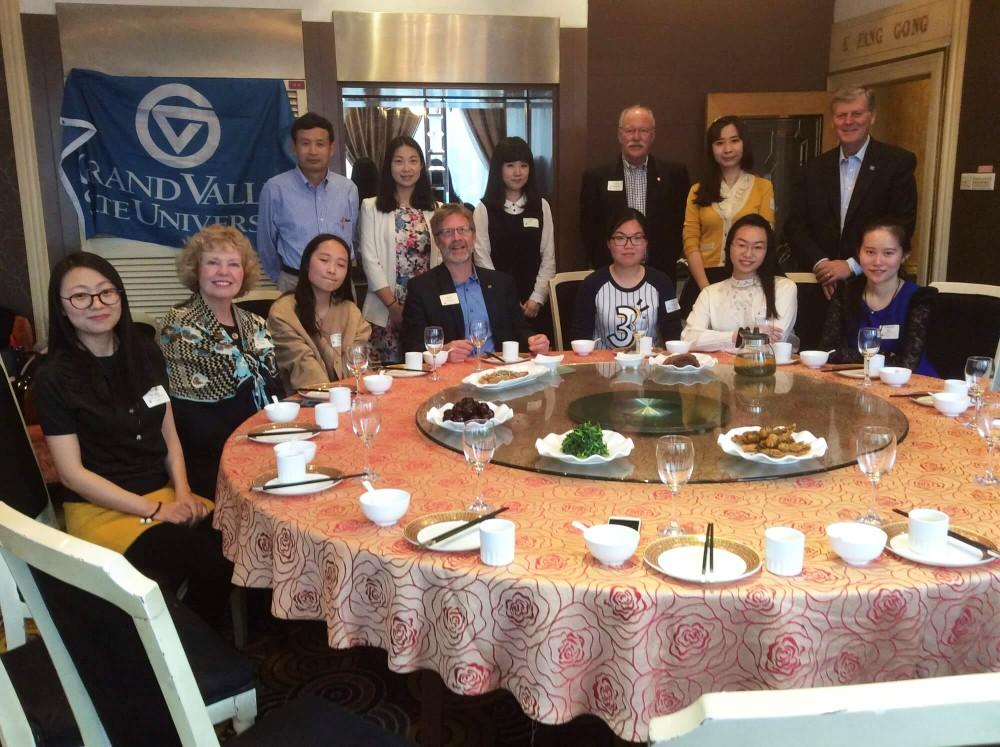 GVL / Courtesy - GVSU.eduShinian Wu, far left, director of the graduate program for applied linguistics, visits Xian International Studies University in 2016 with President Thomas J. Haas (far right).